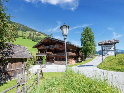 a wooden building with a street light in front of it at Pretty Apartment in Oberau with Infrared Sauna in Oberau