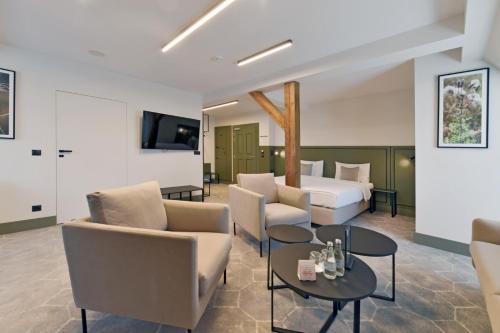 a hotel room with a bed and chairs and a table at Herbal Hotel Wrocław in Wrocław
