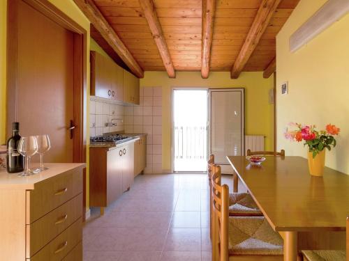 a kitchen with a wooden ceiling and a table at Holiday Home in Sciacca with Garden, Swimming Pool, Parking in Cartabubbo