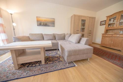 a living room with a couch and a table at Ferienwohnung Boje 9 in Schillig