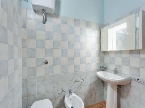 a bathroom with a toilet and a sink at Scenic Apartment in Casole d'Elsa with Pool in Casole dʼElsa