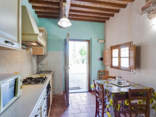a kitchen with a table and a counter top at Scenic Apartment in Casole d'Elsa with Pool in Casole dʼElsa