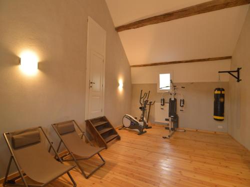 an empty room with chairs and a gym at Luxurious castle in Marchin with infrared sauna in Tharoul