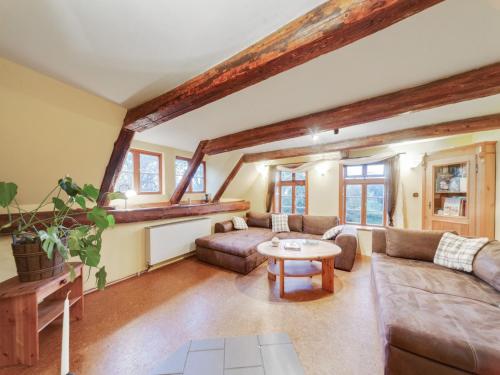 a living room with a couch and a table at Historic Farmhouse in Hohnebostel with Garden near Lake in Langlingen