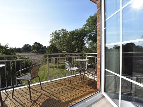 a balcony with chairs and a table with a view at Charming Apartment in Oldenburg in Holstein with Terrace in Oldenburg in Holstein