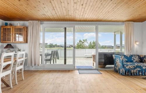 a living room with a couch and a table at 4 Bedroom Beautiful Home In Thisted in Torsted