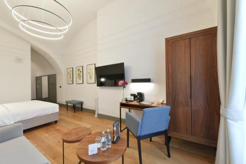 a hotel room with a bed and a desk and a room at Herbal Hotel Wrocław in Wrocław