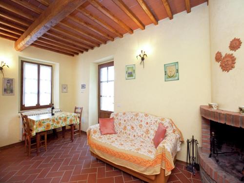 a living room with a couch and a fireplace at Detached villa for 6-pers with outdoor swimming pool in Loro Ciuffenna