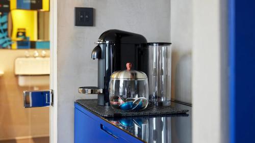 a tea kettle on top of a stove in a kitchen at L7 MYEONGDONG by LOTTE in Seoul