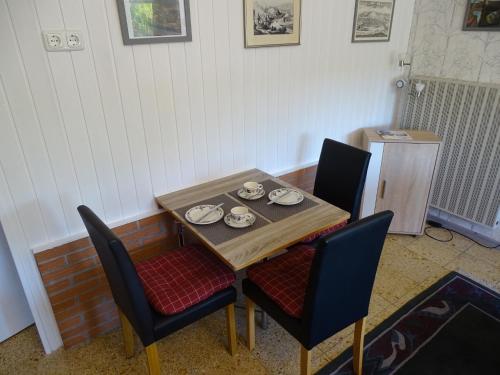 a table with two chairs and a plate on it at Palzem Riverside Escape in Wehr