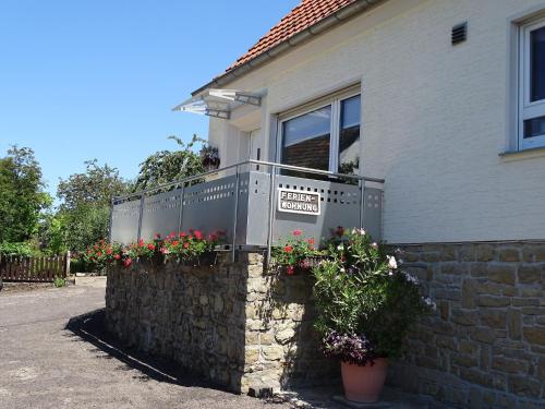 a house with flowers on a stone wall at Palzem Riverside Escape in Wehr