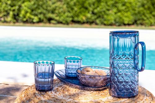 a group of blue glass vases sitting on a table at Italian Experience- Poggio Padule in San Venanzo