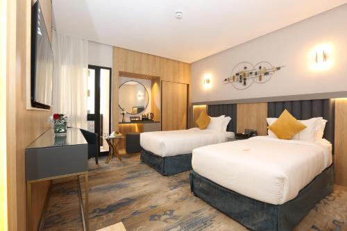 Ένα ή περισσότερα κρεβάτια σε δωμάτιο στο AW Hotel Riyadh