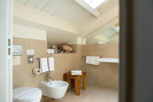 a bathroom with a white toilet and a sink at Hotel 900 in Giulianova