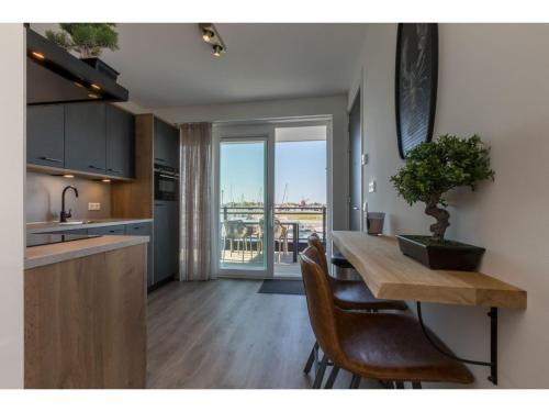 a kitchen with a table with a plant on it at Unique apartment, located on the Oosterschelde and marina of Sint Annaland in Sint Annaland