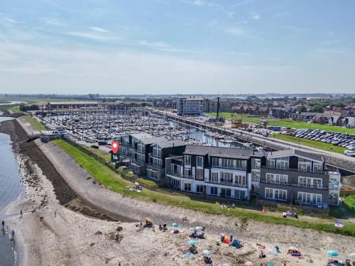 an aerial view of a beach with a parking lot at Unique apartment, located on the Oosterschelde and marina of Sint Annaland in Sint Annaland