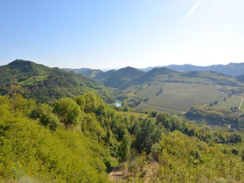 a view of a valley with trees and mountains at Apartment in quiet and green environment with swimming pool in Modigliana
