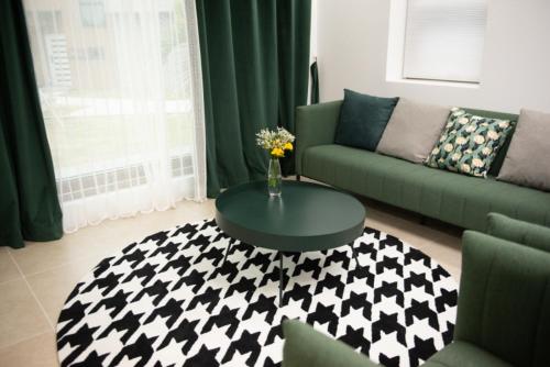 a living room with a table and a couch at Wonderpool pension in Jeju