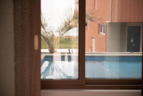 a view of a swimming pool through a window at Wonderpool pension in Jeju