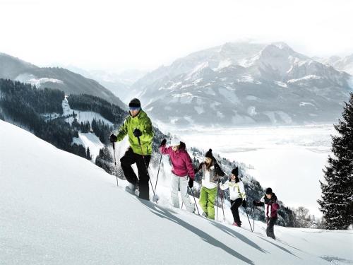 a group of people skiing down a snow covered slope at Apartment in Piesendorf near Ski Slopes in Piesendorf