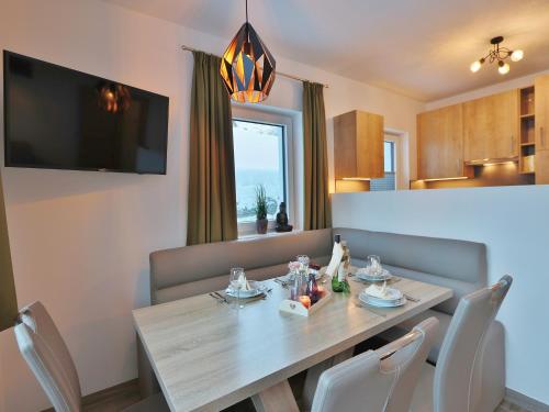 a dining room with a wooden table and chairs at Apartment in Piesendorf near Ski Slopes in Piesendorf