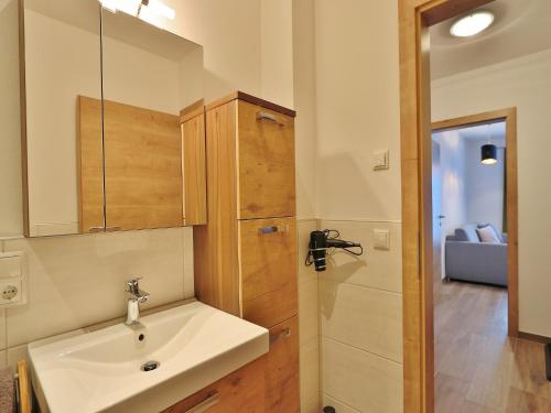 a bathroom with a white sink and a shower at Apartment in Piesendorf near Ski Slopes in Piesendorf