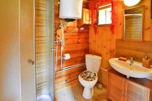 a bathroom with a toilet and a sink at Holiday home in Osieki near a lake in Osieki
