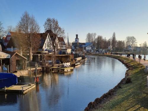 a river with a group of houses and boats on it at Apartment in Luckaitztal-Gossda with parking space in Zwietow