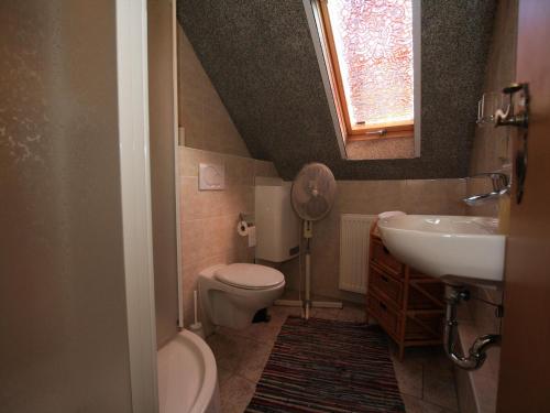 a small bathroom with a sink and a toilet at Apartment in Luckaitztal-Gossda with parking space in Zwietow
