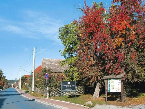 a tree on the side of a road with a sign at Apartment in Luckaitztal-Gossda with parking space in Zwietow