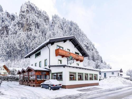 a large white building with a balcony in the snow at Apartment in Strass im Zillertal in a beautiful setting in Strass im Zillertal