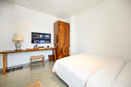 a bedroom with a bed and a desk with a computer at Sky Gem Central Hotel in Ho Chi Minh City