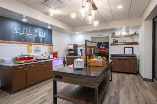 a large kitchen with a table in a room at Hampton Inn & Suites Wilder in Wilder