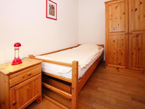 a small bedroom with a bed and a dresser at Holiday resort in the Müritz National Park, Mirow in Mirow