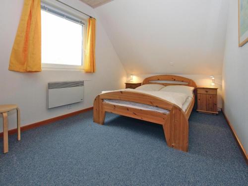 a bedroom with a wooden bed and a window at Holiday resort in the Müritz National Park, Mirow in Mirow