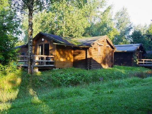 a log cabin in the middle of a field at Ferienhaus in Hechthausen mit Terrasse in Hechthausen