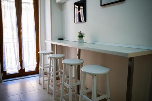 una cocina con una barra con 4 taburetes en Sogni Mediterranei, en San Giorgio a Cremano