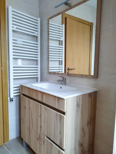 a bathroom with a sink and a mirror at Casa da Zurja in Guarda
