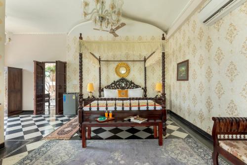 a bedroom with a bed and a checkered floor at SaffronStays Raj Reverie in Jaipur