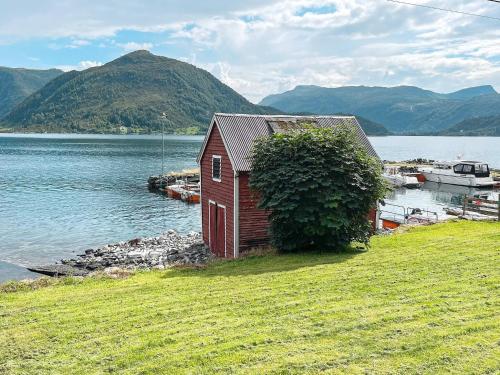 a small house on the shore of a body of water at 8 person holiday home in Barmen in Barmen