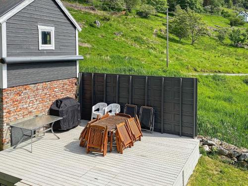 a patio with a table and chairs on a deck at 8 person holiday home in Barmen in Barmen