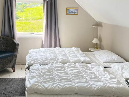 a bedroom with two beds in front of a window at 8 person holiday home in Barmen in Barmen