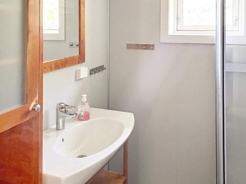 a bathroom with a sink and a mirror at 8 person holiday home in Barmen in Barmen