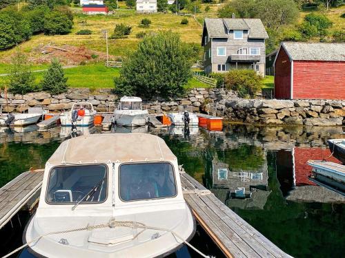 a boat is docked at a dock in the water at 8 person holiday home in Barmen in Barmen