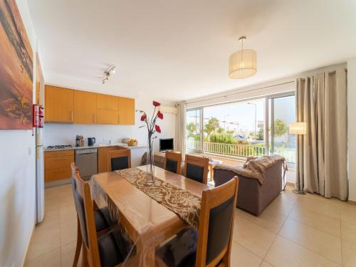 a kitchen and dining room with a table and a couch at An Idyllic Algarve Home by the Water in Fuzeta