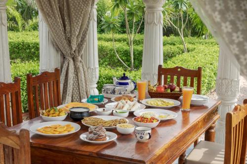 a wooden table with food on top of it at SaffronStays Raj Reverie in Jaipur