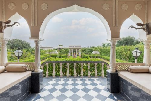 a view from the porch of a mansion with two beds at SaffronStays Raj Reverie in Jaipur
