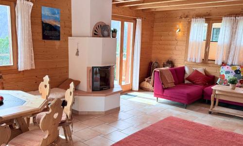 a living room with a couch and a table at Chalet Poiema in Bellwald