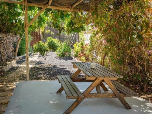 a wooden picnic table and bench under a pergola at Holiday home in Malpais de Candelaria with a terrace in Bence