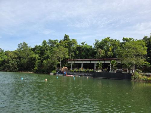 a view of a lake with a building in the background at Lake View Resort in Ban Nam Rop